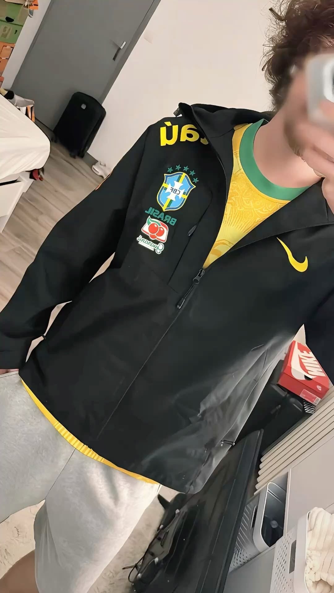 Black jacket with yellow details and light trousers
